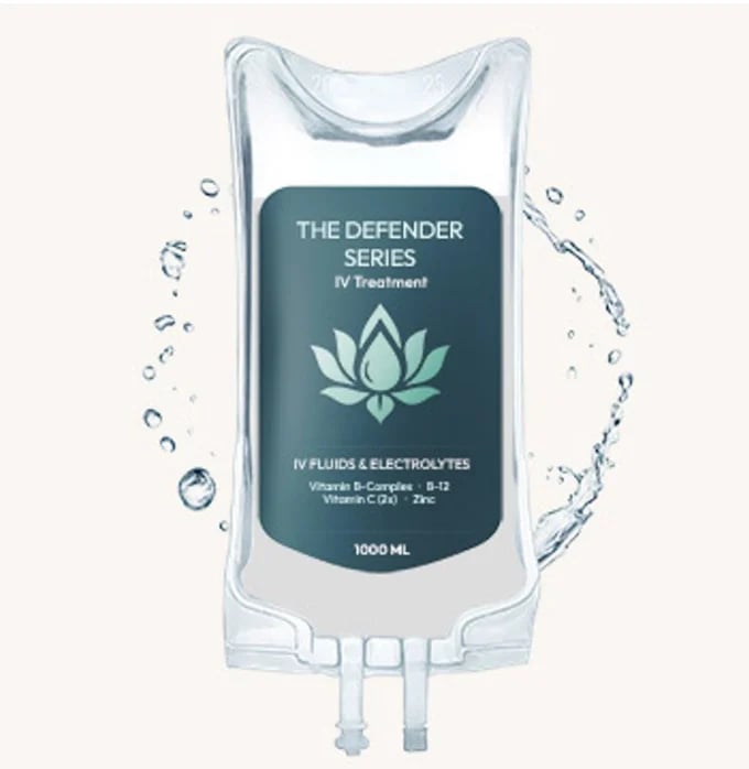 Clear IV bag labeled The Defender Series with lotus symbol, shown with water splashing around it